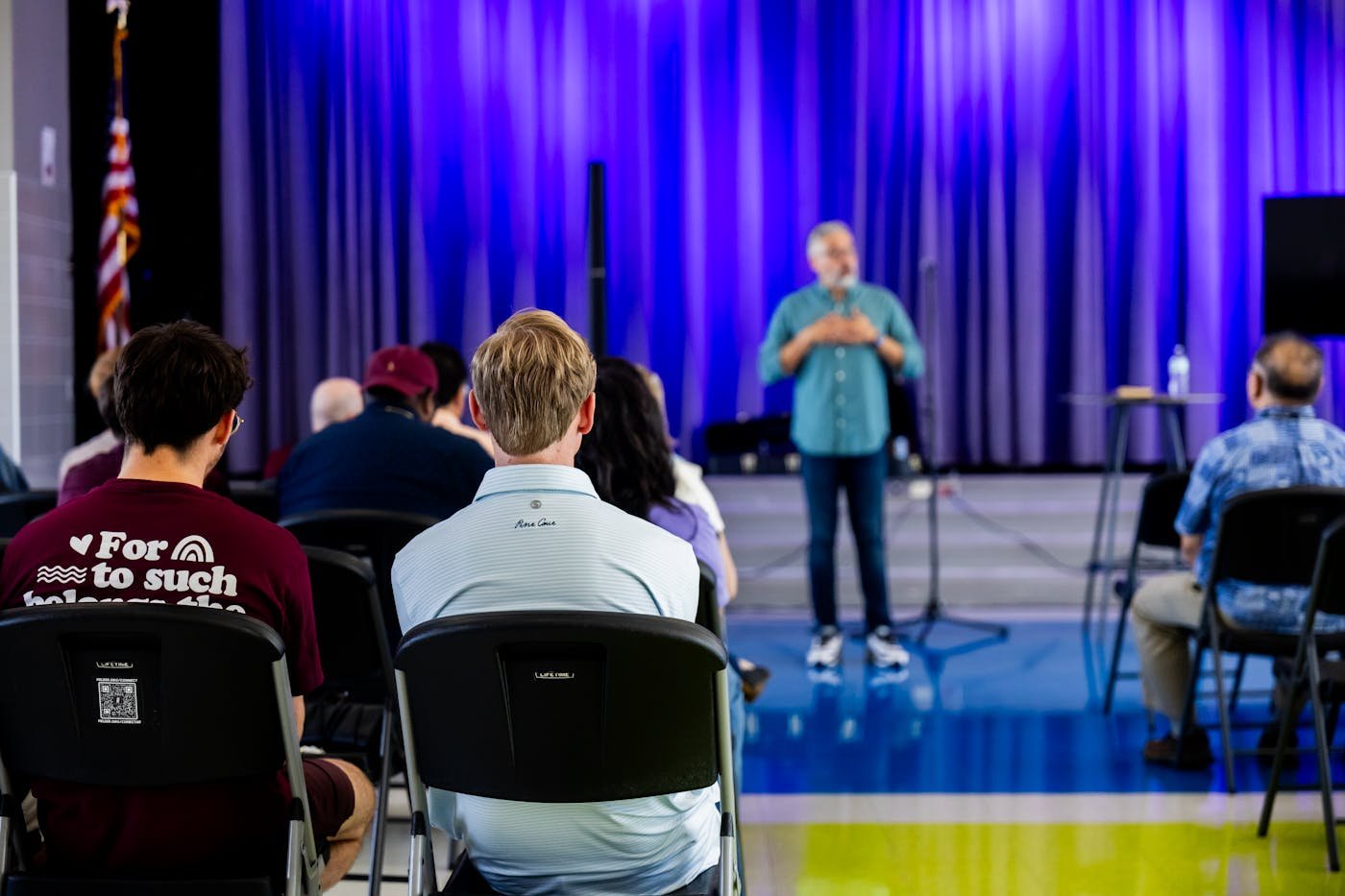 Audience watching a live event presentation for event marketing and sponsorship ideas
