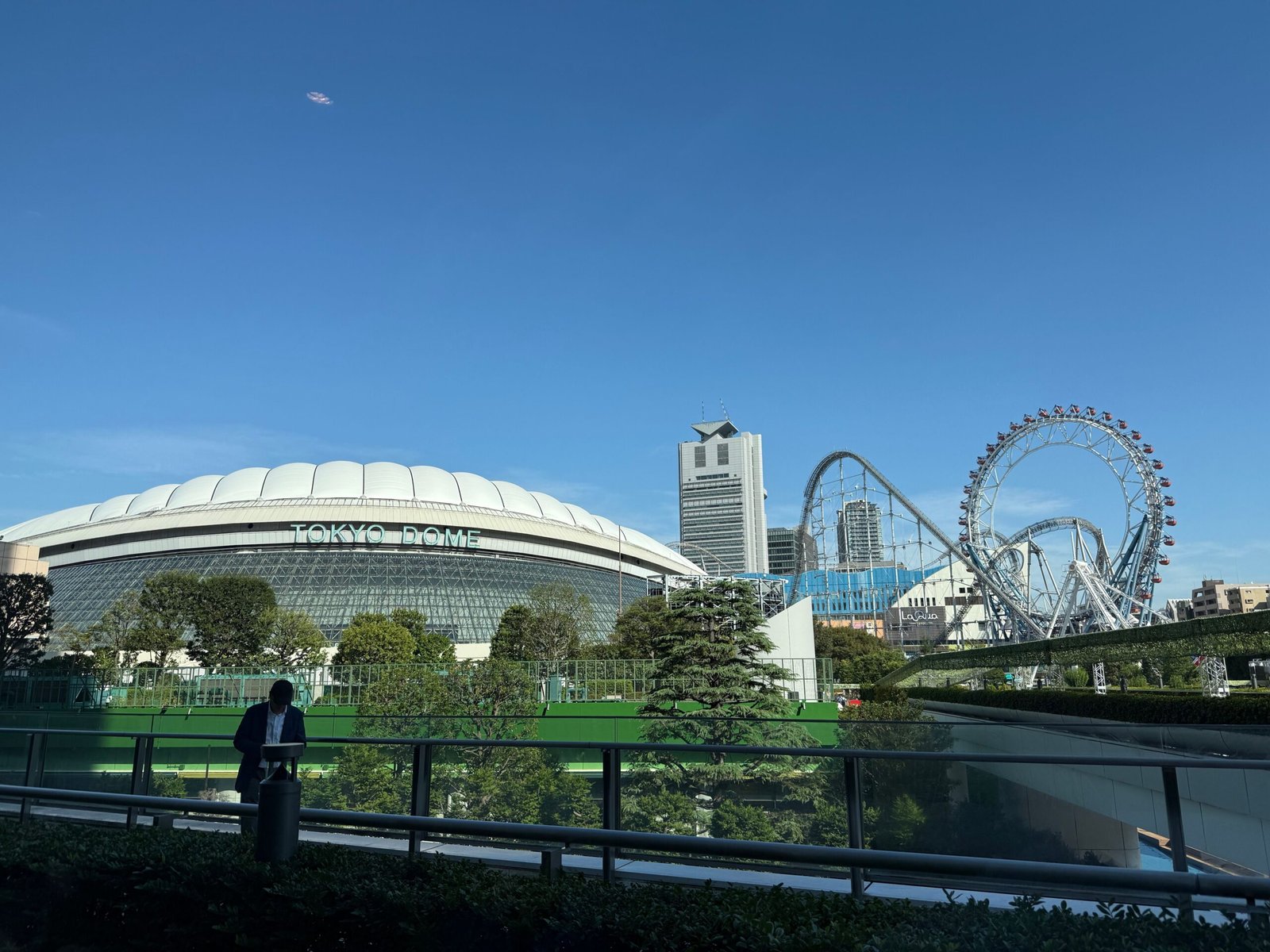 Tokyo Dome exterior with amusement rides and Tokyo skyline